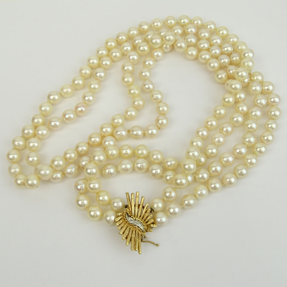 Long Vintage Double Strand White Pearl Necklace with 14 Karat Yellow Gold Clasp with Small Diamond Accents.