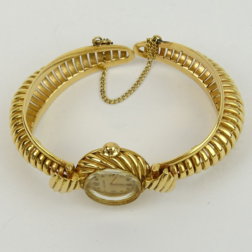 Lady's Vintage 14 Karat Yellow Gold Movado Bangle Bracelet Watch with Manual Movement.