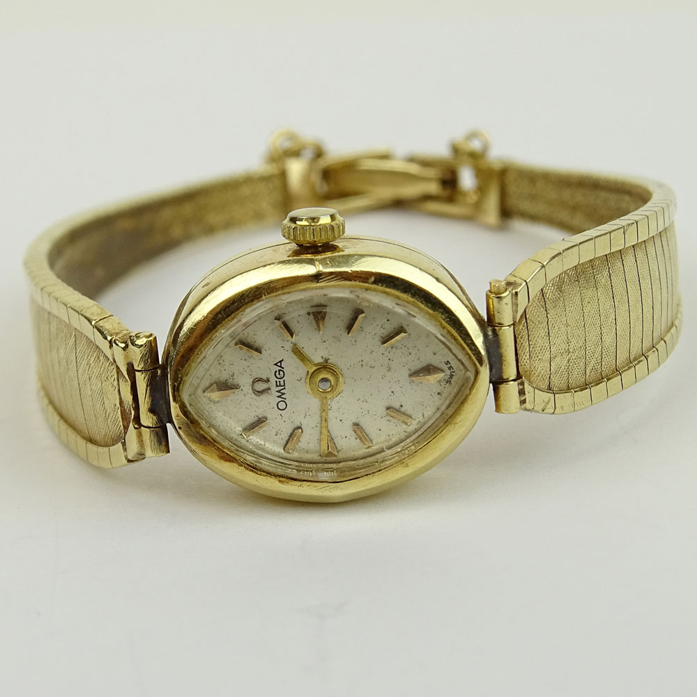 Lady's Vintage 14 Karat Yellow Gold Omega Bracelet Watch with Quartz Movement.