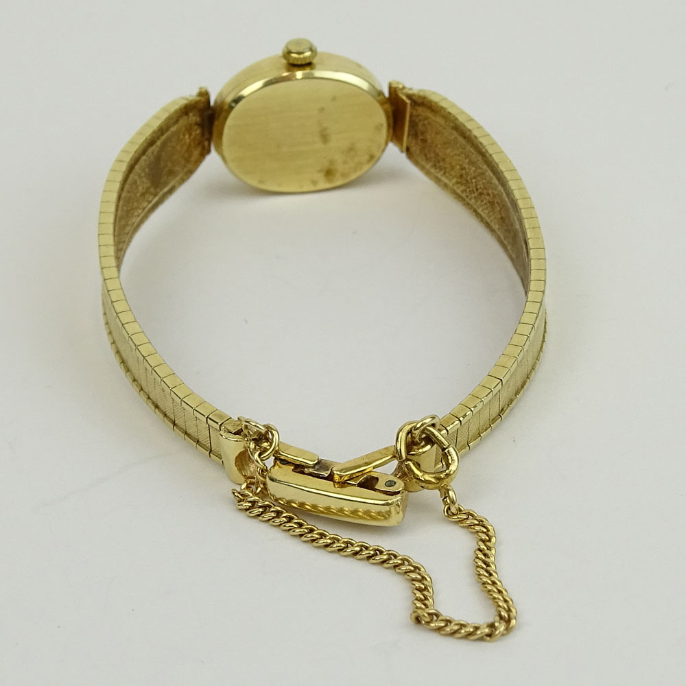 Lady's Vintage 14 Karat Yellow Gold Omega Bracelet Watch with Quartz Movement.