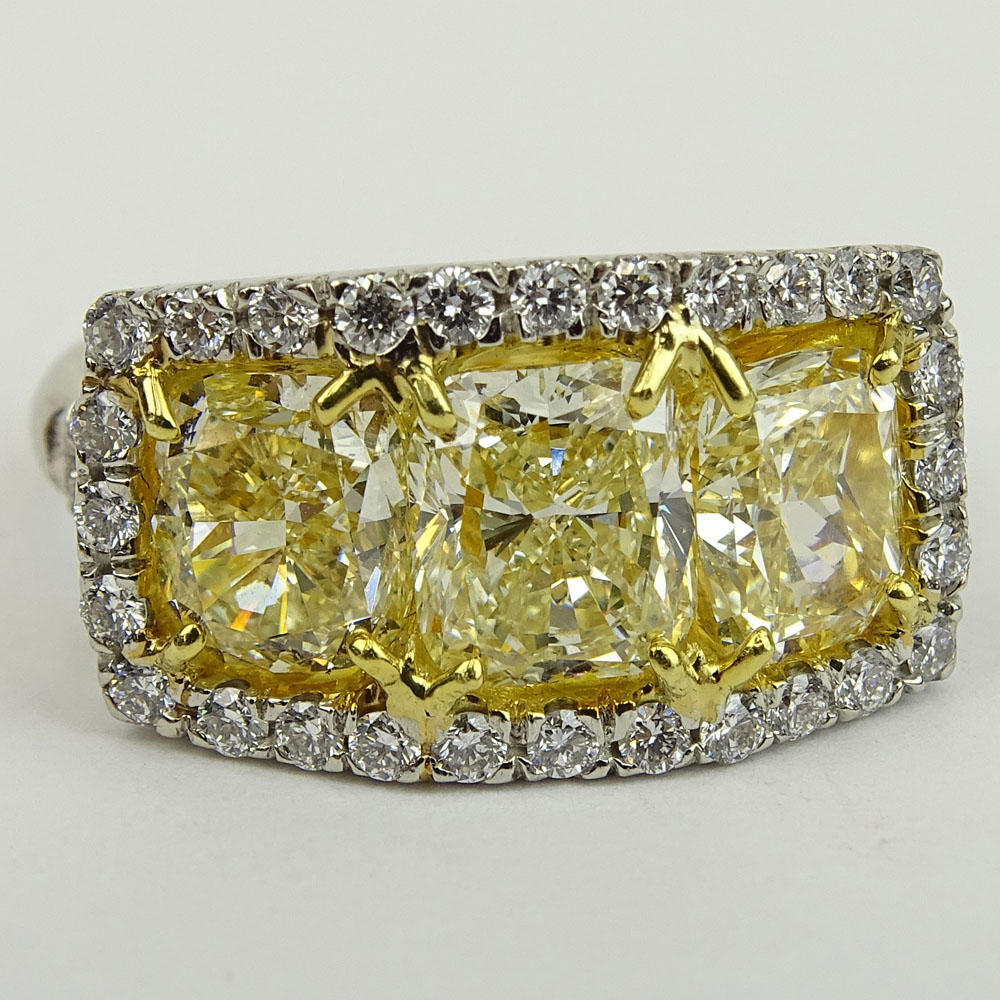 Fancy Yellow Diamond and Platinum Three Stone Ring Set with Three (3) Cushion Cut Diamonds