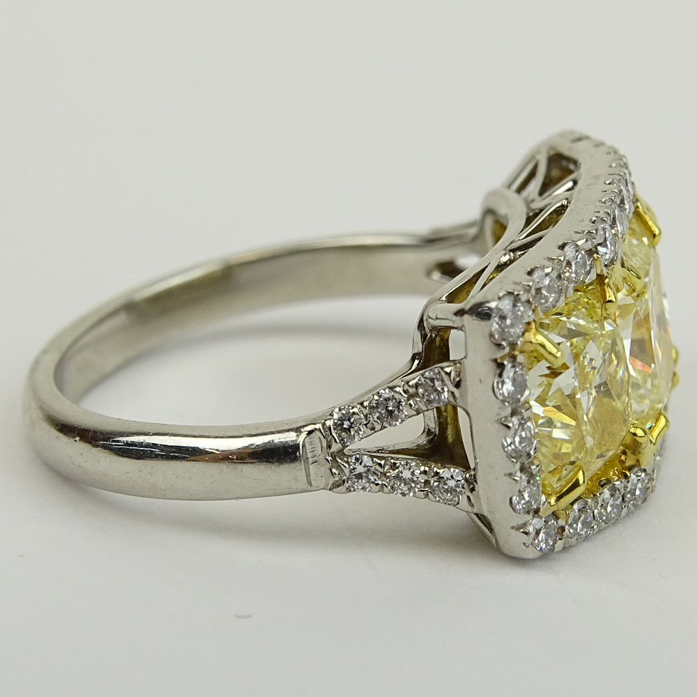 Fancy Yellow Diamond and Platinum Three Stone Ring Set with Three (3) Cushion Cut Diamonds