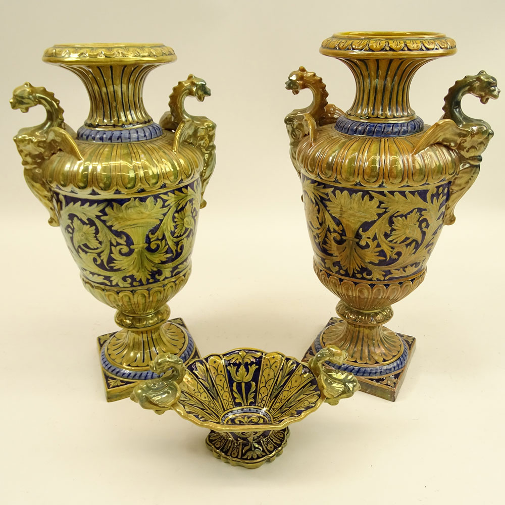 Three Pieces Early 20th Century Robbia Gualdo Tadino Painted Majolica Urns and compote. Chimera handles.