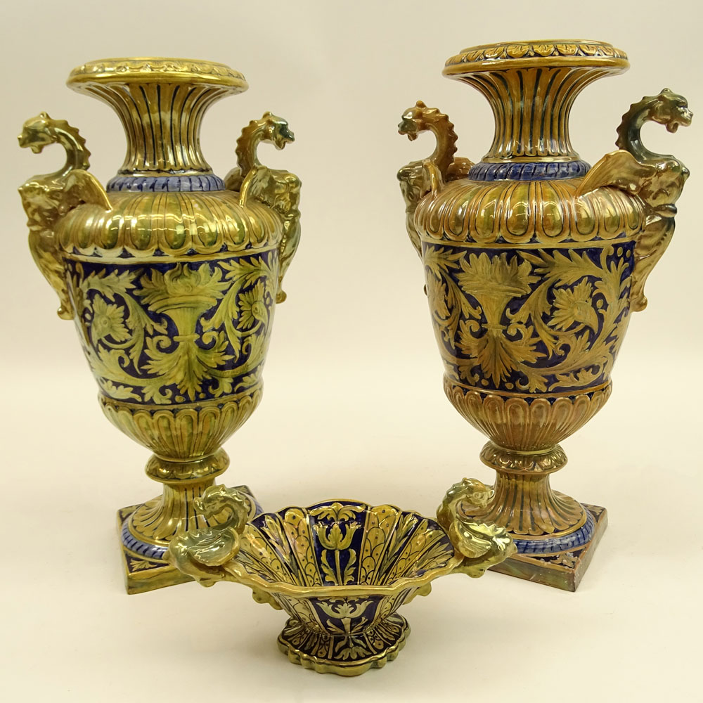 Three Pieces Early 20th Century Robbia Gualdo Tadino Painted Majolica Urns and compote. Chimera handles.