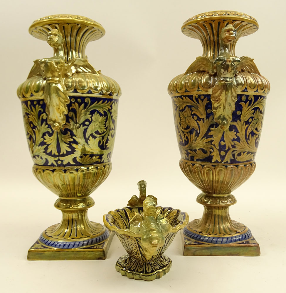 Three Pieces Early 20th Century Robbia Gualdo Tadino Painted Majolica Urns and compote. Chimera handles.