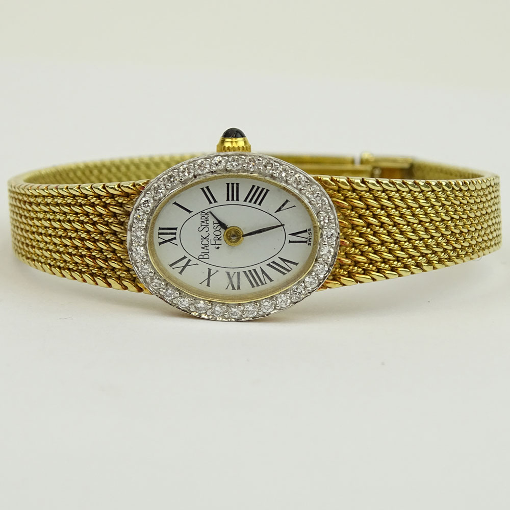 Lady's Black Starr & Frost 14 Karat Yellow Gold Bracelet Watch with Round Brilliant Cut Diamond Bezel. Quartz movement.