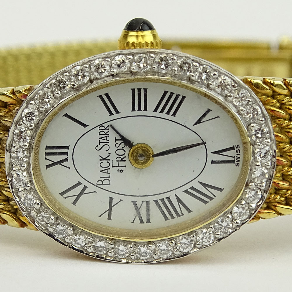 Lady's Black Starr & Frost 14 Karat Yellow Gold Bracelet Watch with Round Brilliant Cut Diamond Bezel. Quartz movement.