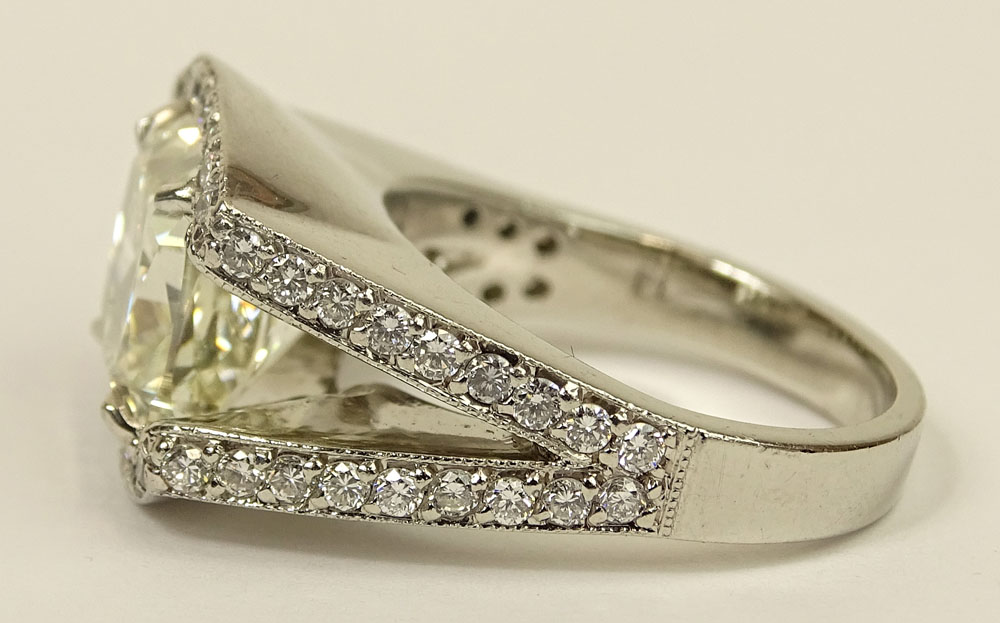 Important Approx. 7.01 Carat Cushion Cut Diamond and Platinum Ring accented with Micro Pave Set Diamonds Throughout.