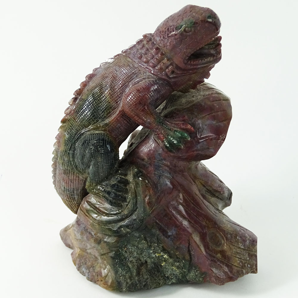 Carved Rhodonite Iguana Figure. With forked tongue perched on a limb.