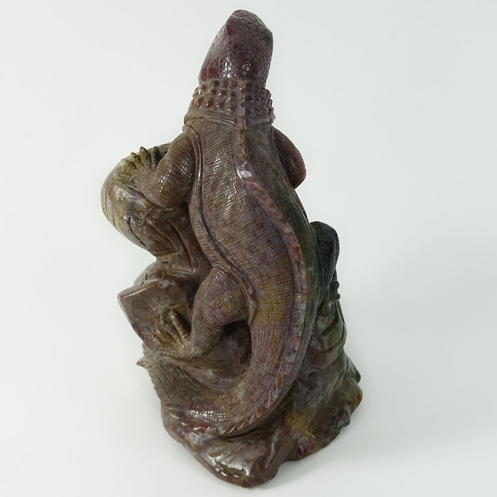 Carved Rhodonite Iguana Figure. With forked tongue perched on a limb.