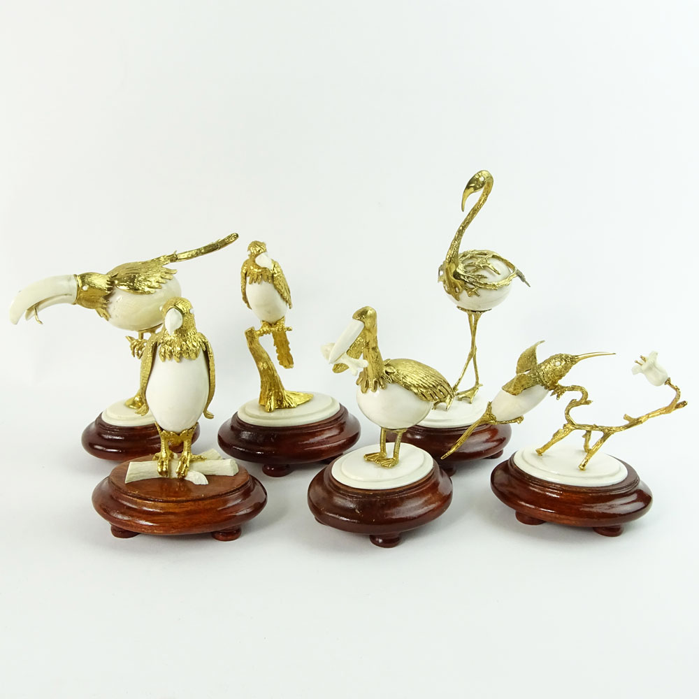 Boxed set of Ivory and 18K Gilt Metal Exotic Bird Figurines. Each bird hand carved and mounted in 18K gold plated metal.