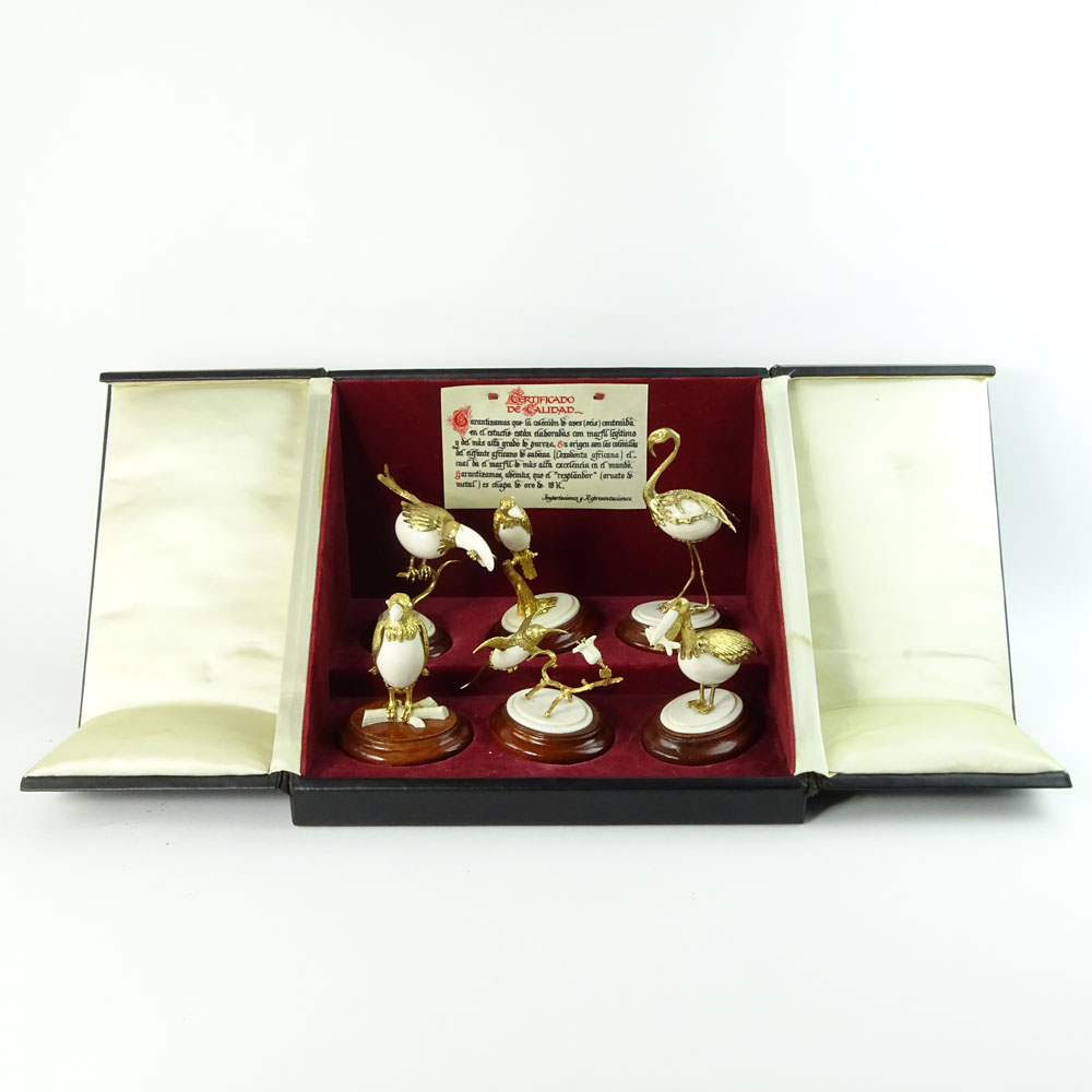 Boxed set of Ivory and 18K Gilt Metal Exotic Bird Figurines. Each bird hand carved and mounted in 18K gold plated metal.