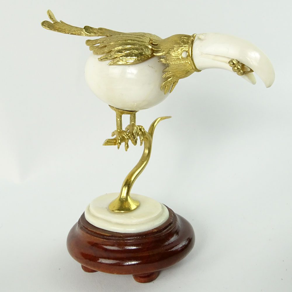 Boxed set of Ivory and 18K Gilt Metal Exotic Bird Figurines. Each bird hand carved and mounted in 18K gold plated metal.