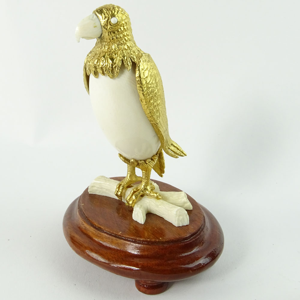 Boxed set of Ivory and 18K Gilt Metal Exotic Bird Figurines. Each bird hand carved and mounted in 18K gold plated metal.