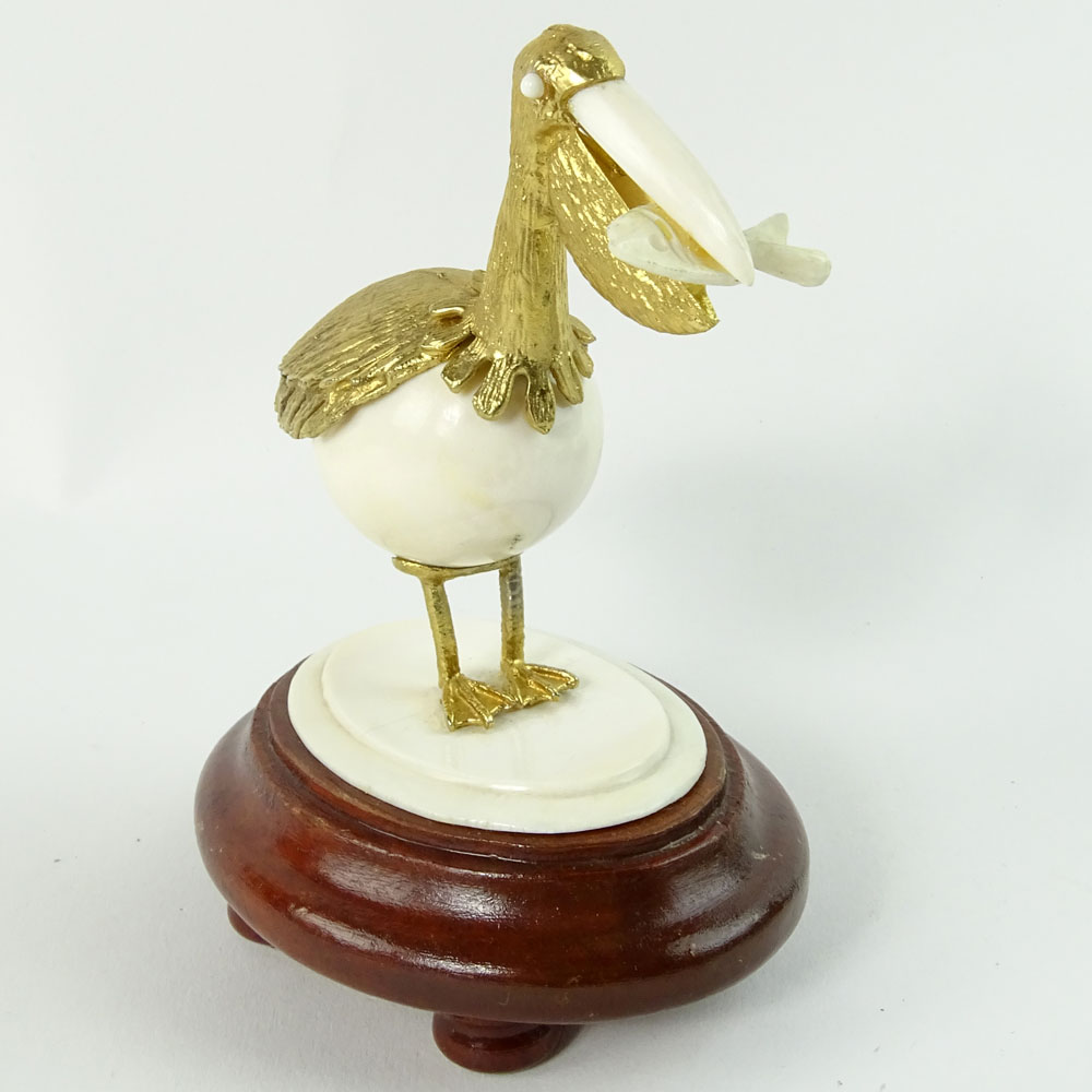 Boxed set of Ivory and 18K Gilt Metal Exotic Bird Figurines. Each bird hand carved and mounted in 18K gold plated metal.