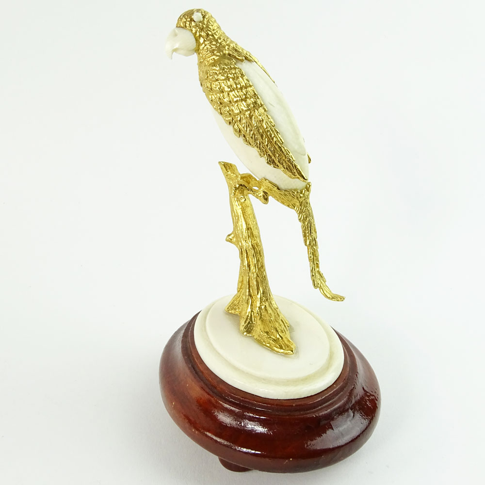 Boxed set of Ivory and 18K Gilt Metal Exotic Bird Figurines. Each bird hand carved and mounted in 18K gold plated metal.