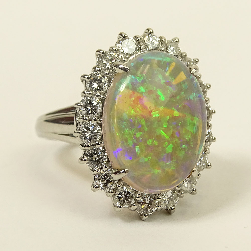 Lady's Oval Cut White Opal, Approx. 1.0 Carat Round Brilliant Cut Diamond and Platinum Ring. 