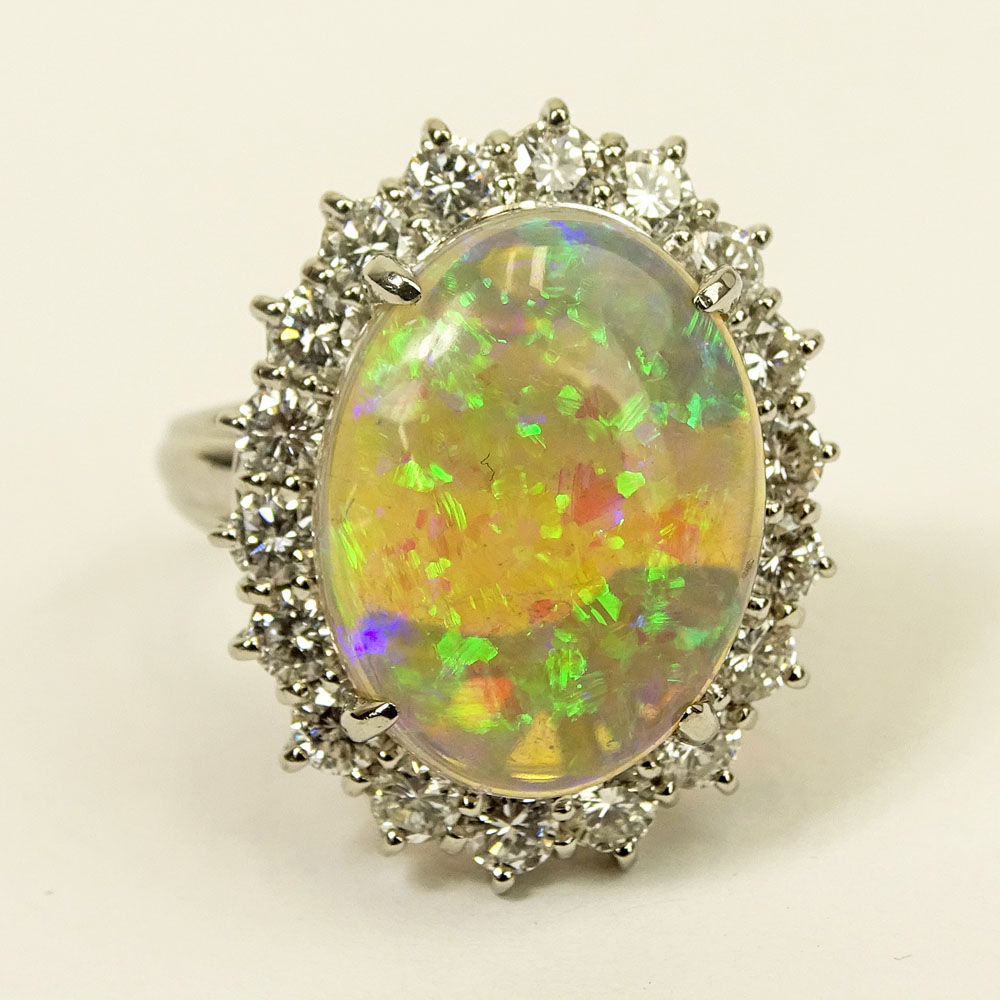 Lady's Oval Cut White Opal, Approx. 1.0 Carat Round Brilliant Cut Diamond and Platinum Ring. 