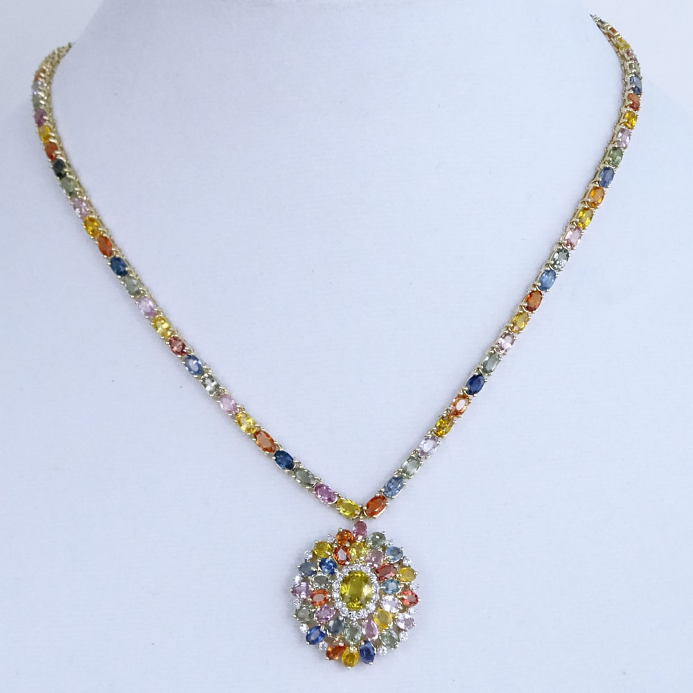 AIG Certified 35.53 Carat Oval Cut Multicolor Sapphire, .65 Carat Round Brilliant Cut diamond and 14 Karat Yellow Gold Pendant Necklace. 