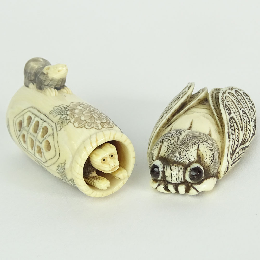 Two Carved Netsuke. One in the form of a cricket.cicaida, the other a moveable monkey coming out of a basket. 