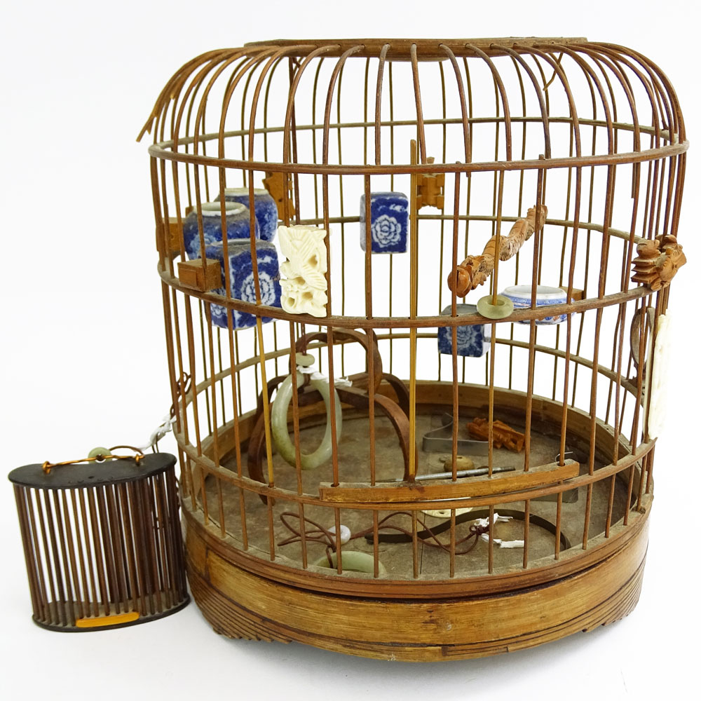 Early 20th Century Chinese Carved Wood Hanging Birdcage with Blue and White Porcelain Feeders, Jade Swings and Carved Ivory Ornaments Together with Attached Cricket Cage.