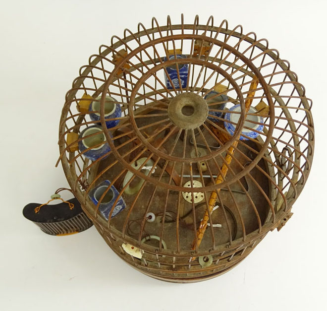 Early 20th Century Chinese Carved Wood Hanging Birdcage with Blue and White Porcelain Feeders, Jade Swings and Carved Ivory Ornaments Together with Attached Cricket Cage.