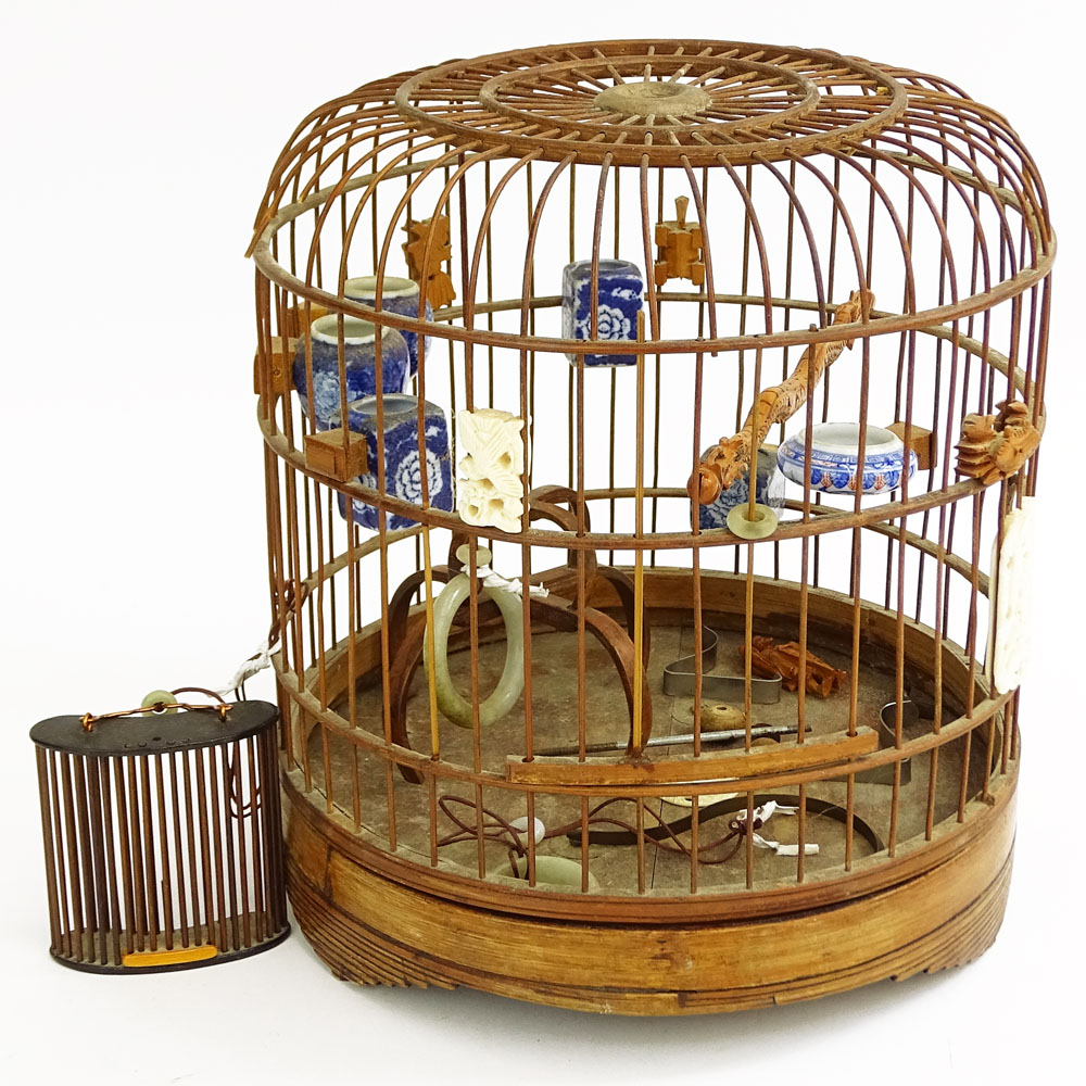 Early 20th Century Chinese Carved Wood Hanging Birdcage with Blue and White Porcelain Feeders, Jade Swings and Carved Ivory Ornaments Together with Attached Cricket Cage.