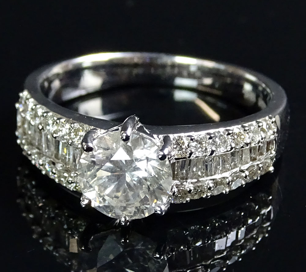 AIG Certified 1.85 Carat Diamond and 18 Karat White Gold Engagement Ring set in the center with a 1.23 Carat Round Brilliant Cut Diamond and accented with .62 Carat Round Brilliant and Baguette Cut Diamonds.