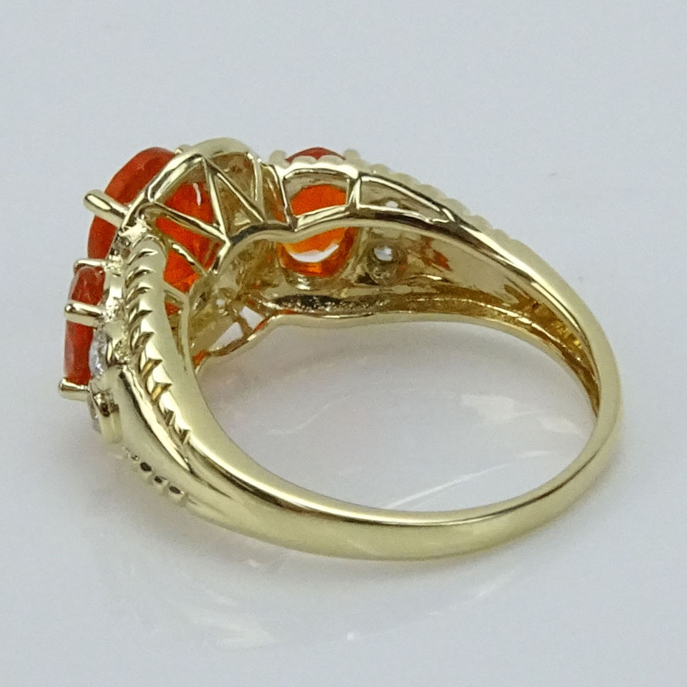 Approx. 1.37 Carat Fire Opal, .75 Carat Round Cut Diamond and 14 Karat Yellow Gold Three Stone Ring