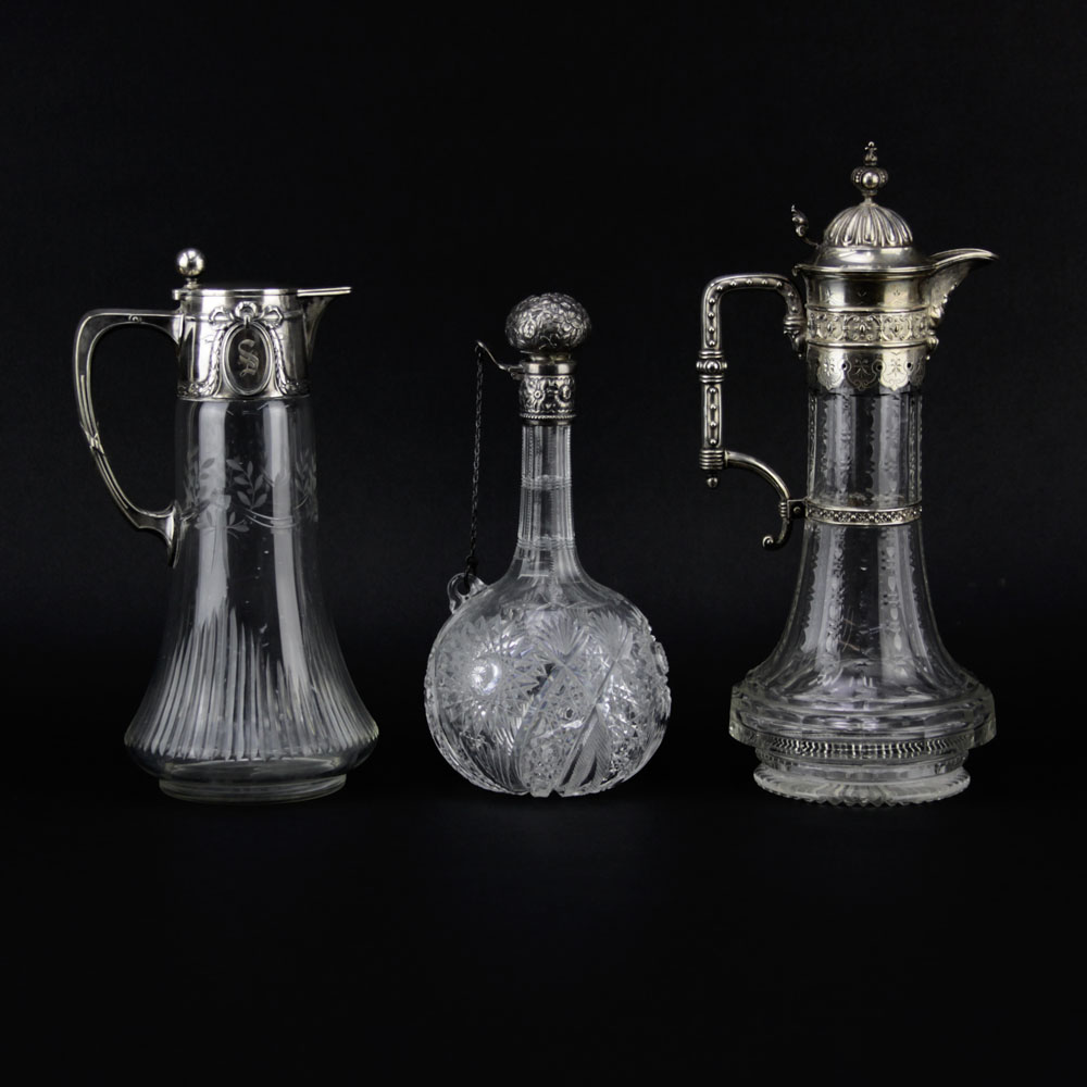Lot of Three Cut Glass Decanters. Includes a Sterling Lidded bottle Marked Sterling