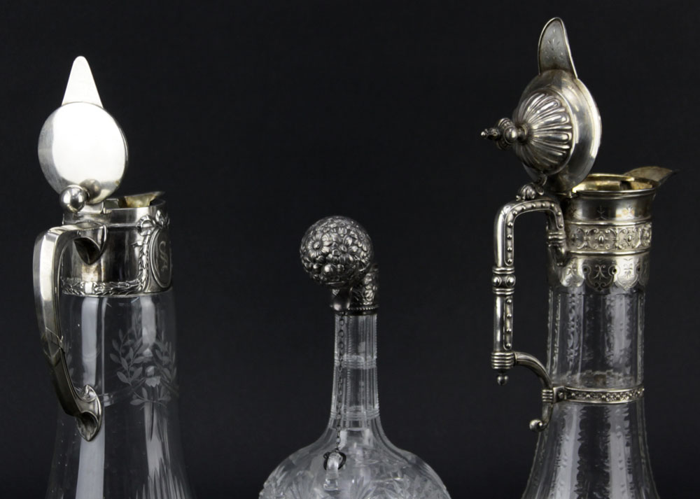 Lot of Three Cut Glass Decanters. Includes a Sterling Lidded bottle Marked Sterling