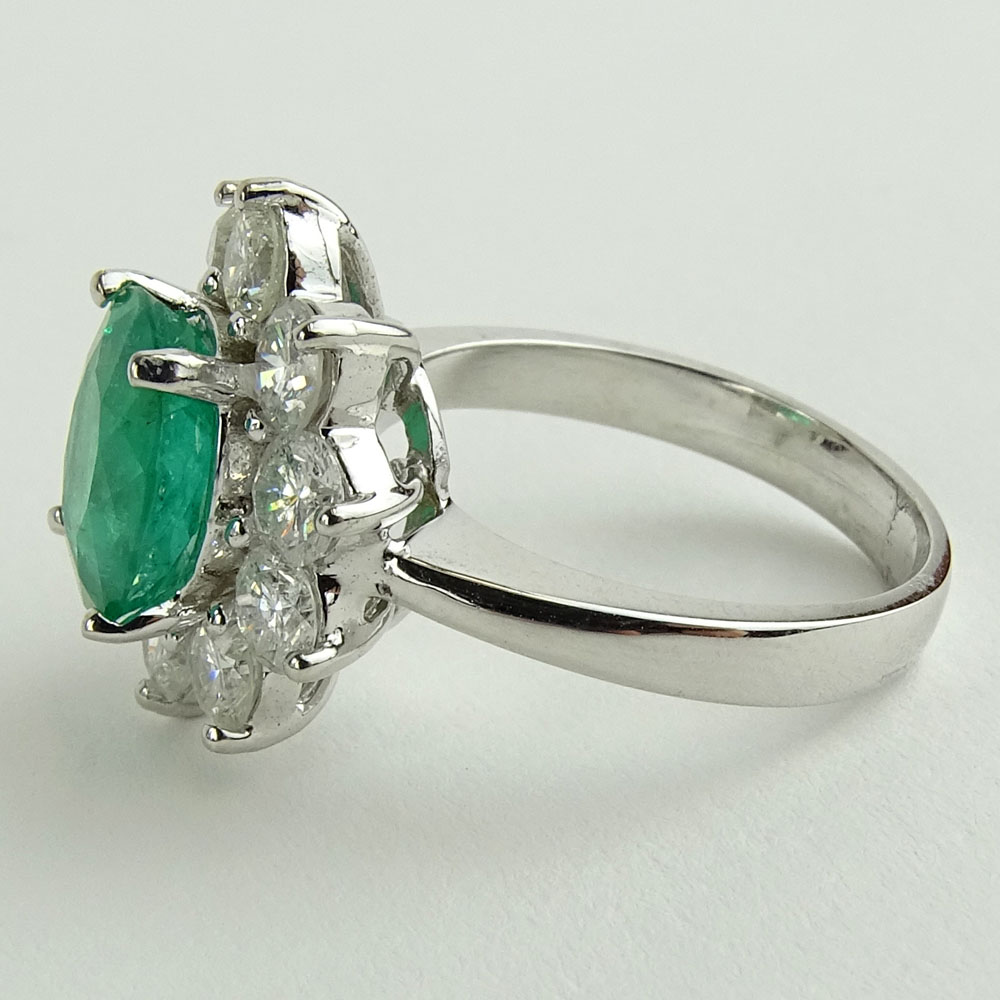 Lady's 2.40 Carat Oval Cut Emerald, 2.15 Carat Round Cut Diamond and 14 Karat White Gold Ring