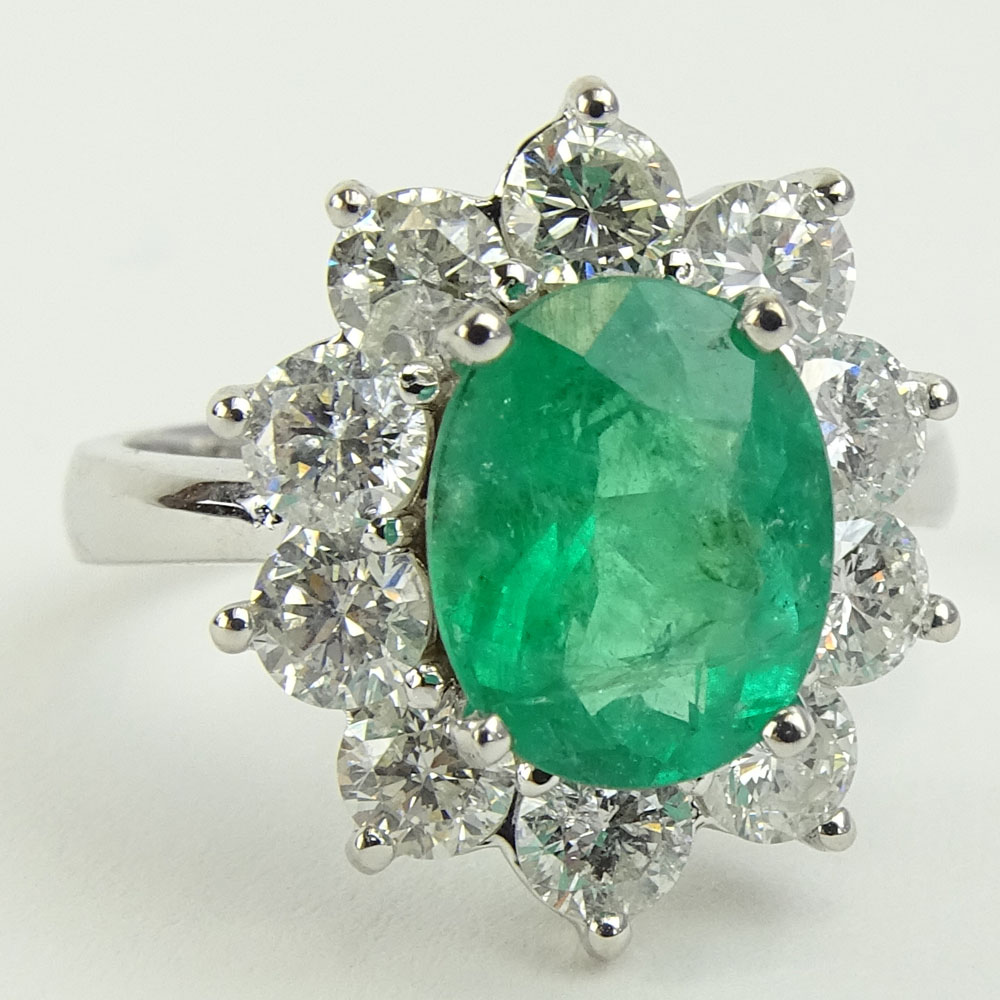 Lady's 2.40 Carat Oval Cut Emerald, 2.15 Carat Round Cut Diamond and 14 Karat White Gold Ring