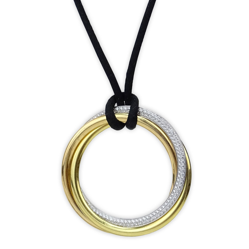 Vintage Cartier Diamond and 18 Karat Tri-color Gold Trinity Pendant Necklace with Black Silk Cord.