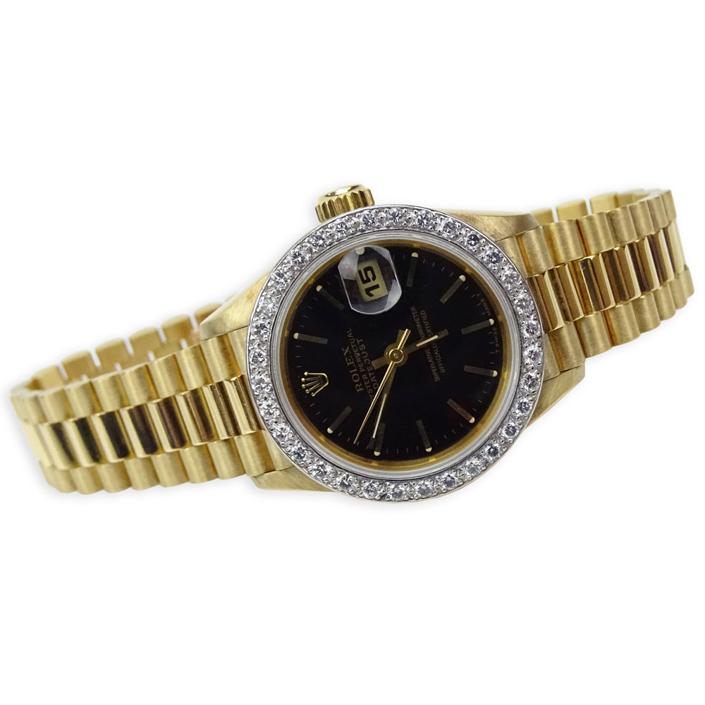 Lady's Vintage Rolex 18 Karat Yellow Gold Datejust Presidential with Diamond Bezel and Black Dial.