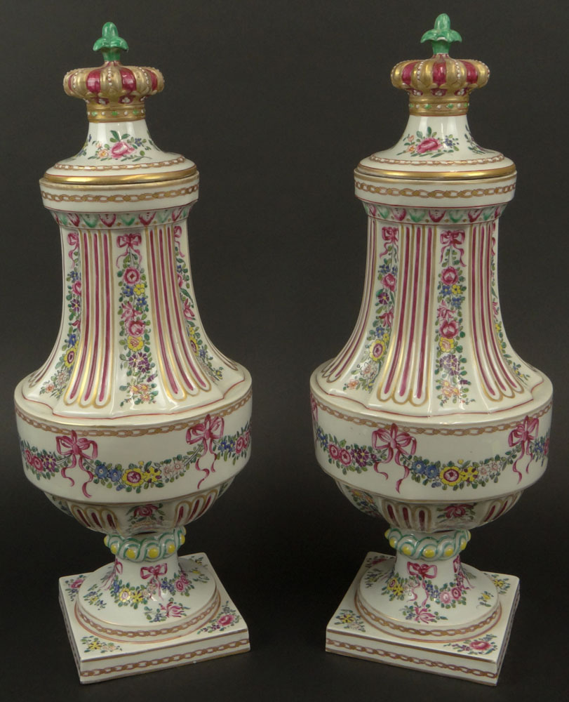 Pair of Early 20th Century French Louis XVI-style Painted Porcelain Urns with Crown Finials.