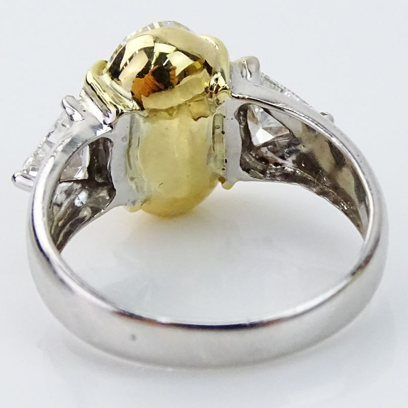 4.07 Carat Oval Cut Fancy Yellow Diamond and 18 Karat White Gold Engagement Ring