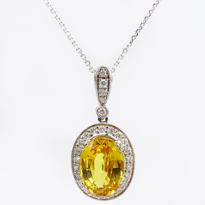 Approx. 6.50 Carat Oval Cut Yellow Sapphire, .63 Carat Diamond and 18 Karat White Gold Pendant with 14 Karat White Gold Chain.