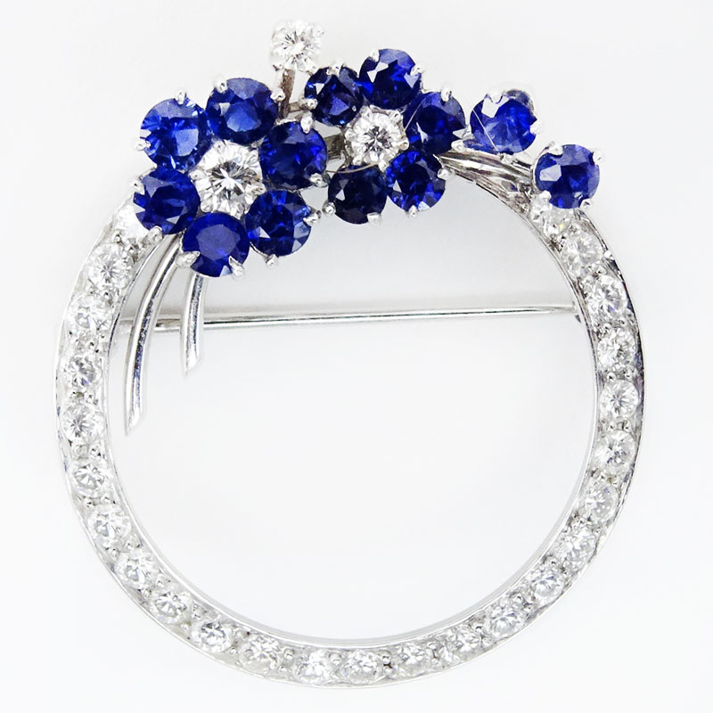 Circa 1940s Approx. .75 Carat Round Brilliant Cut Diamond, 1.50 Carat Sapphire and 18 Karat White Gold Circa Brooch.