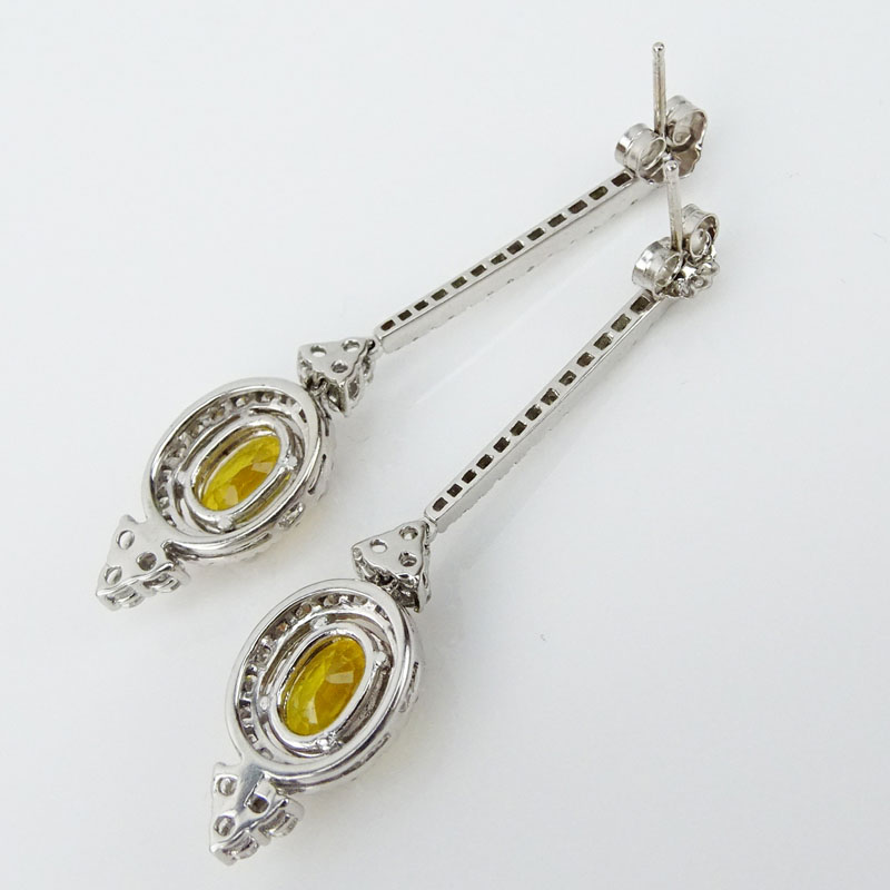 3.20 Carat Oval Cut Yellow Sapphire, 2.30 Carat Round Brilliant Cut Diamond and 14 Karat White Gold Dangle Earrings