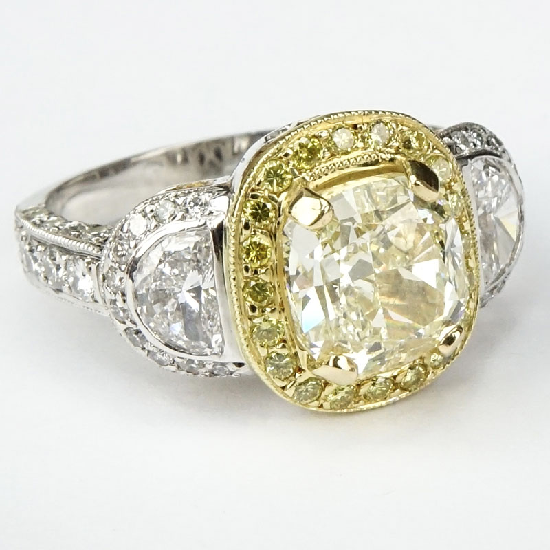 Approx. 3.40 Carat Cushion Cut Fancy Light Yellow Diamond, 1.70 Carat Diamond and Platinum Engagement Ring.