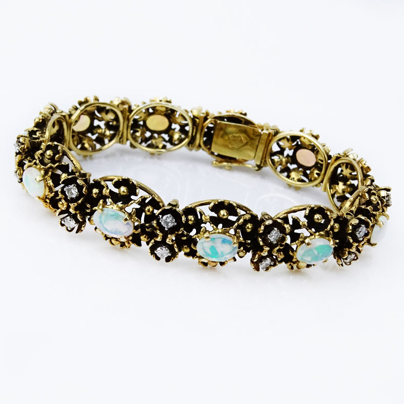 Circa 1970s Victorian style Cabochon Opal, approx. 1.0 Carat Round Brilliant Cut Diamond and 14 Karat Yellow Gold Bracelet. Opals with good play of color.