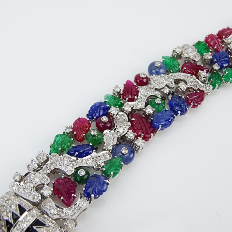 Cartier style 55.50 Carat Carved Emerald, Ruby and Sapphire and 9.15 Carat Round Brilliant Cut Diamond and 18 Karat White Gold Tutti Frutti Bracelet. 