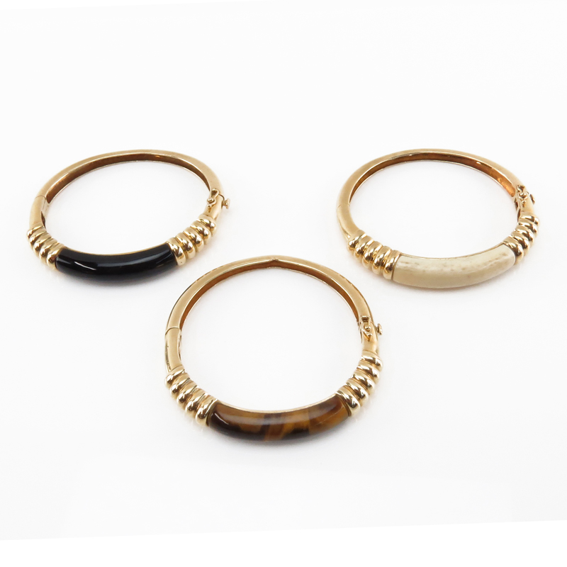 Set of Three Vintage 14 Karat Yellow Gold Bangle Bracelets set with Tiger-eye, Black Onyx and Ivory