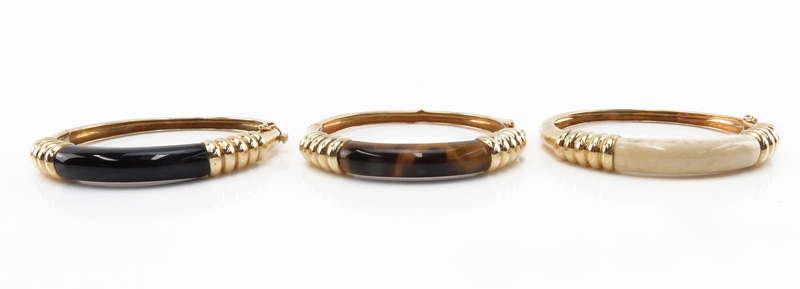 Set of Three Vintage 14 Karat Yellow Gold Bangle Bracelets set with Tiger-eye, Black Onyx and Ivory