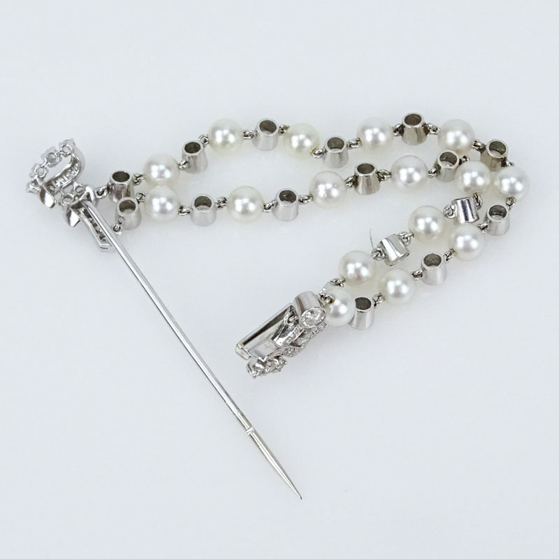 Circa 1940s Approx. 4.0 Carat Round Brilliant Cut Diamond, Pearl and Platinum Bow Brooch