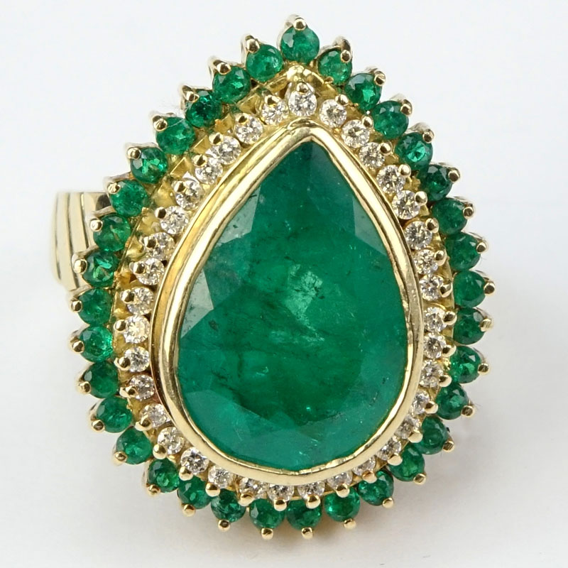 7.50 Carat Pear Shape Colombian Emerald and 18 Karat Yellow Gold Ring accented with .50 Carat Round Brilliant Cut Diamonds and 2.0 Carat Round Cut Emeralds.