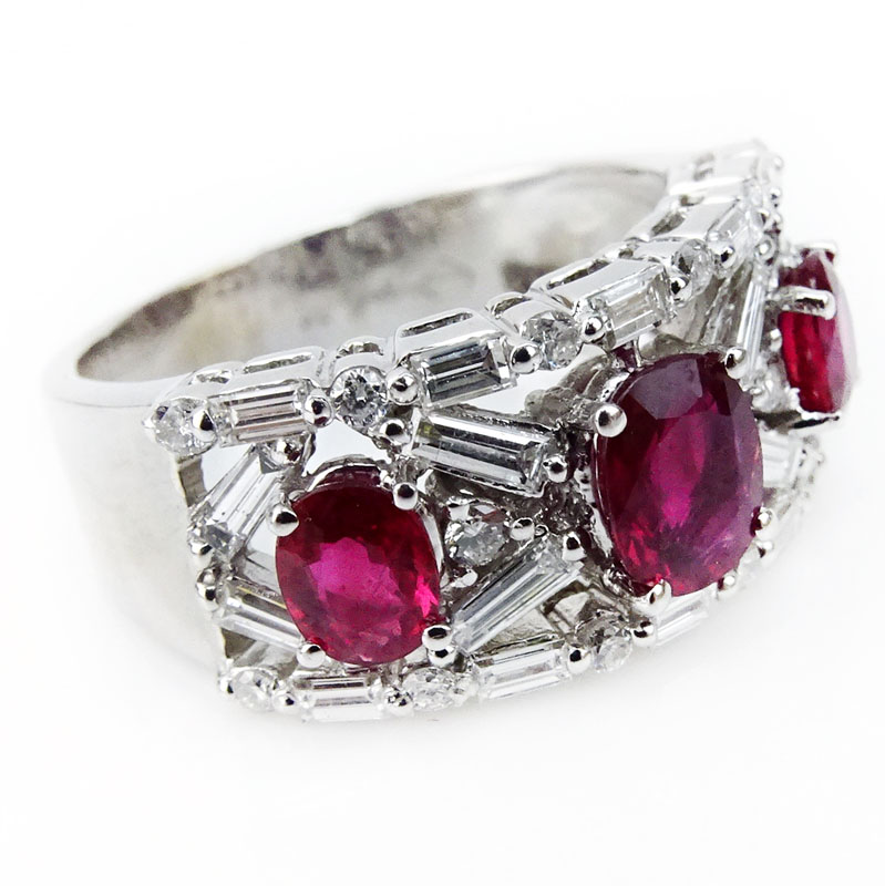 . 2.50 Carat Round Brilliant and Baguette Cut Diamond, Oval Cut Ruby and 18 Karat White Gold Ring. 