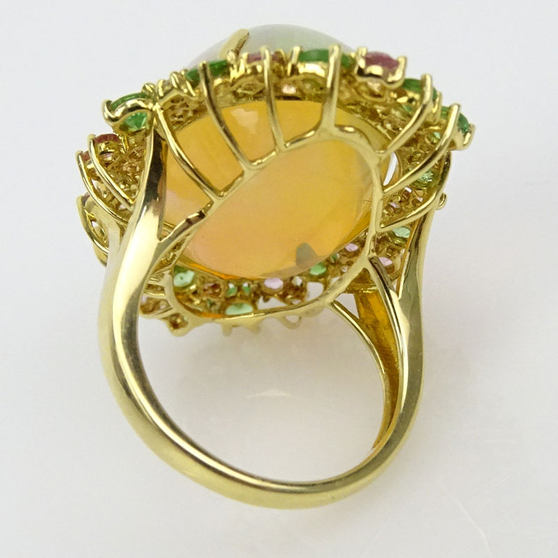 18.03 Carat Oval Cabochon Opal, 2.0 Carat Round Cut Pink and Green Sapphire, .20 Carat Diamond and 18 Karat Yellow Gold Ring. 