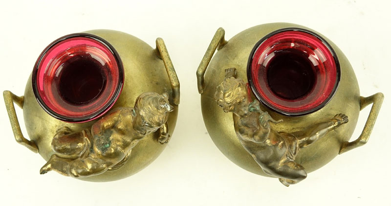 In the Manner of: Aguste Moreau, French (1834-1917) Pair of Art Nouveau Bronze Handle Vases with Cranberry Glass Insert